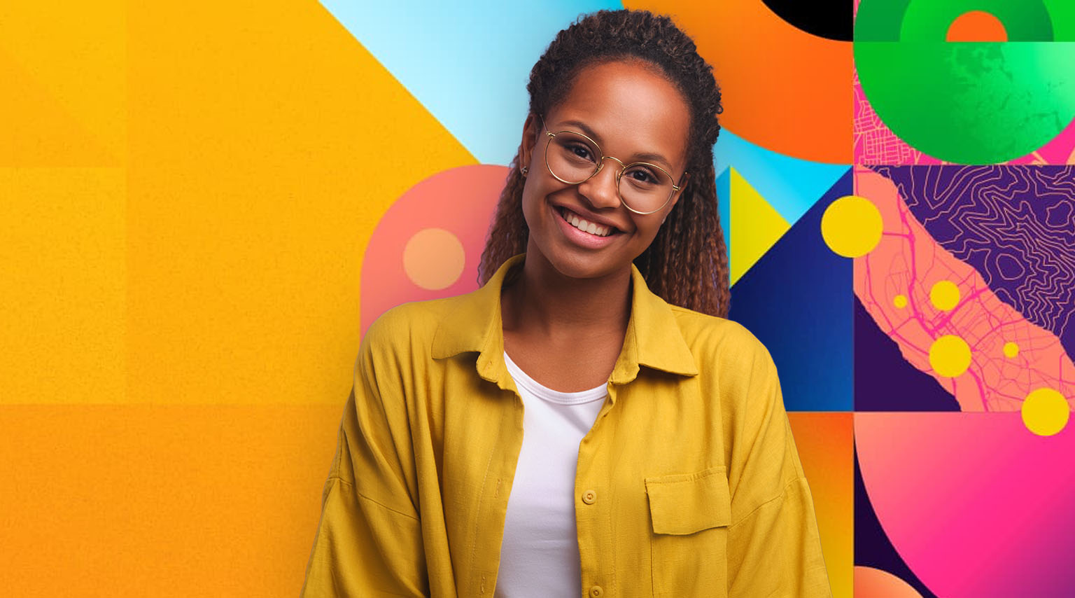 A woman wearing a yellow shirt smiling near artwork representing Esri UC 2025